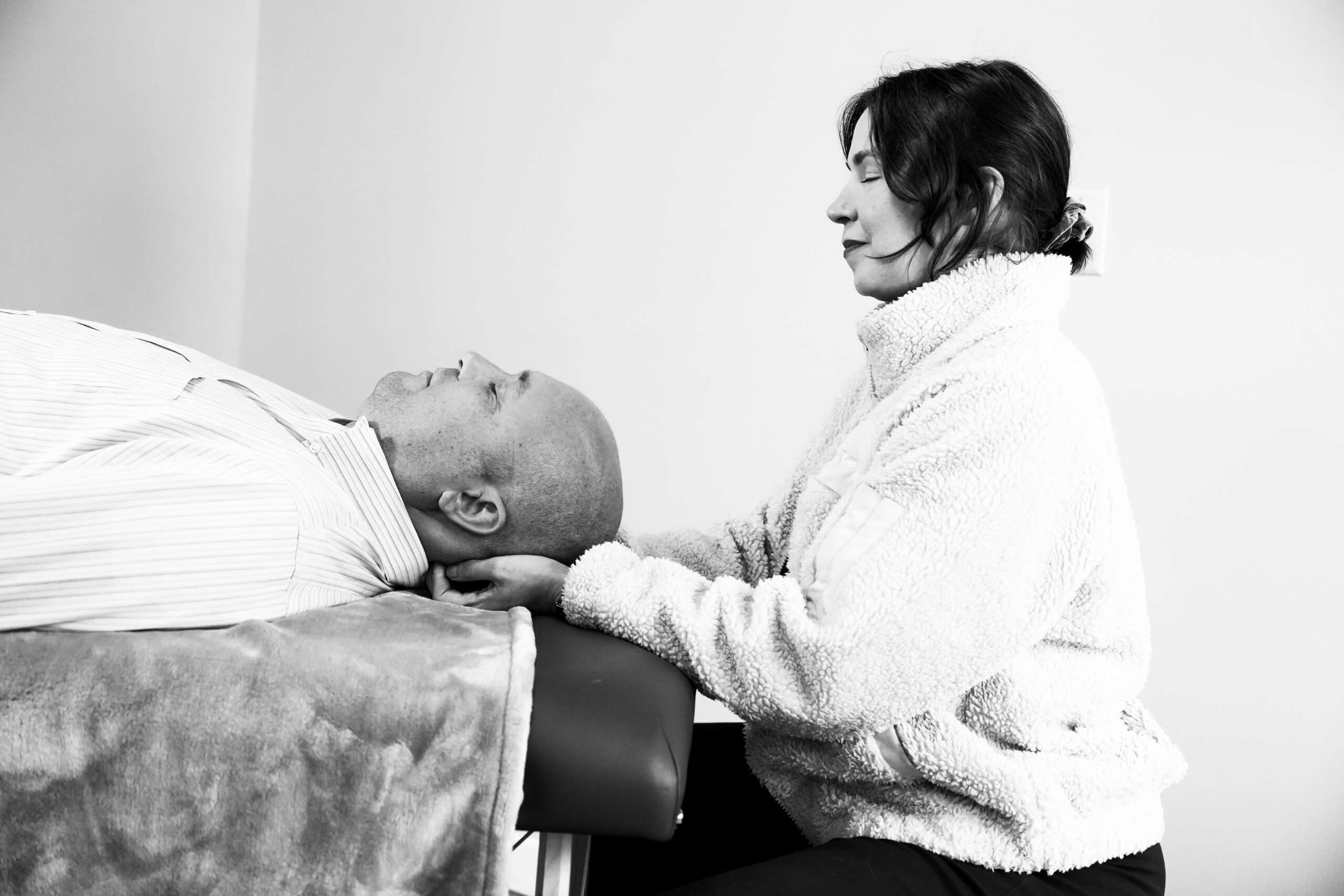 Naturopathic doctor providing hands-on nervous system care to an adult patient at Bendavid Clinic, Burlington VT